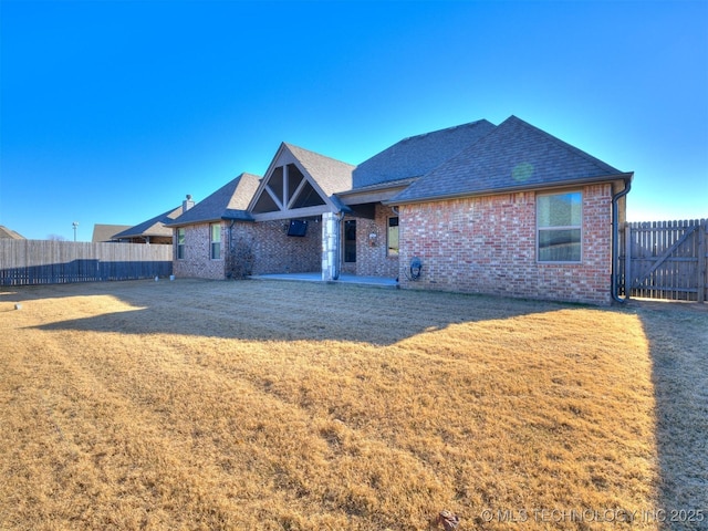 rear view of property featuring a yard