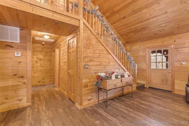 entrance foyer with lofted ceiling, wood-type flooring, wooden ceiling, and wooden walls