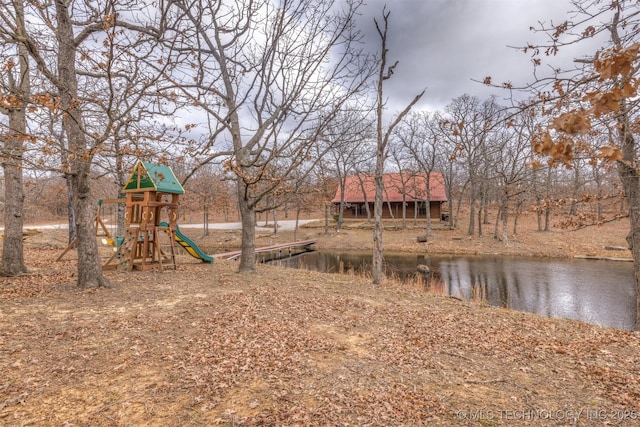 view of yard featuring a playground and a water view