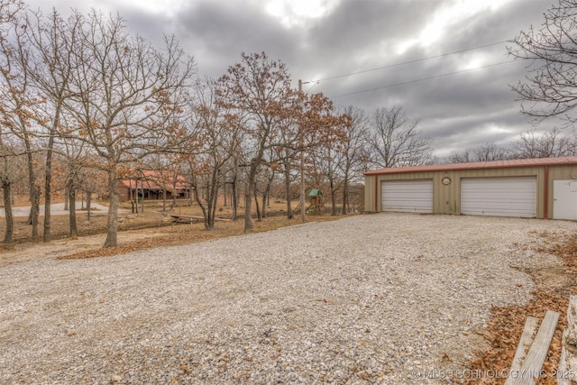 view of yard with a garage and an outdoor structure