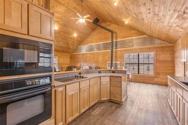 kitchen featuring wood walls, hardwood / wood-style floors, black appliances, light brown cabinetry, and wood ceiling