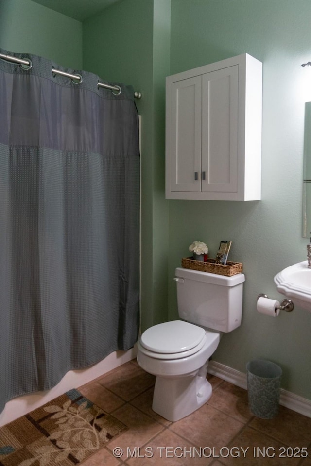 bathroom featuring walk in shower, tile patterned flooring, and toilet