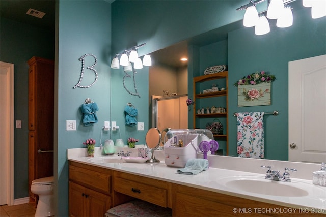 bathroom featuring tile patterned flooring, vanity, and toilet