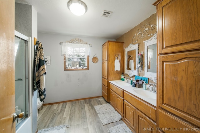 bathroom with hardwood / wood-style floors, vanity, and toilet