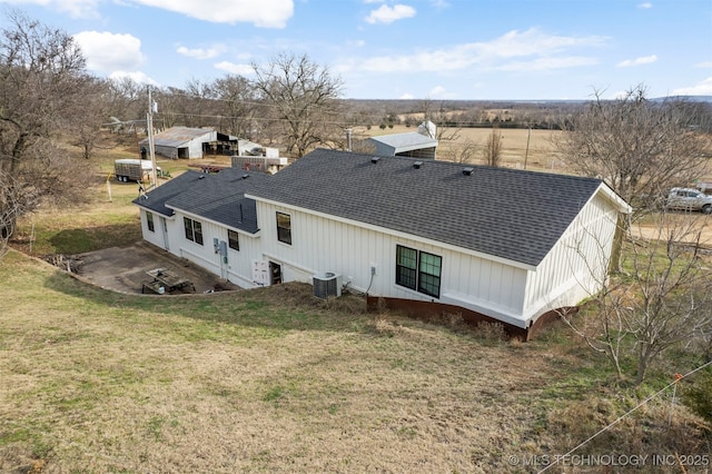 back of house featuring a lawn, a patio, and central AC