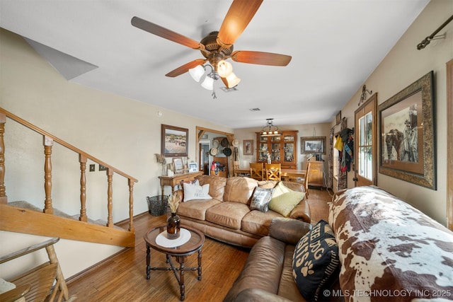 living room featuring hardwood / wood-style floors and ceiling fan