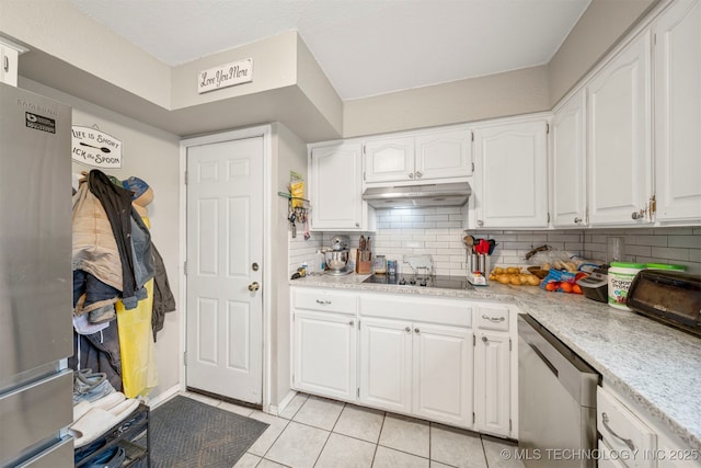 kitchen with white cabinets, stainless steel appliances, tasteful backsplash, and light tile patterned flooring