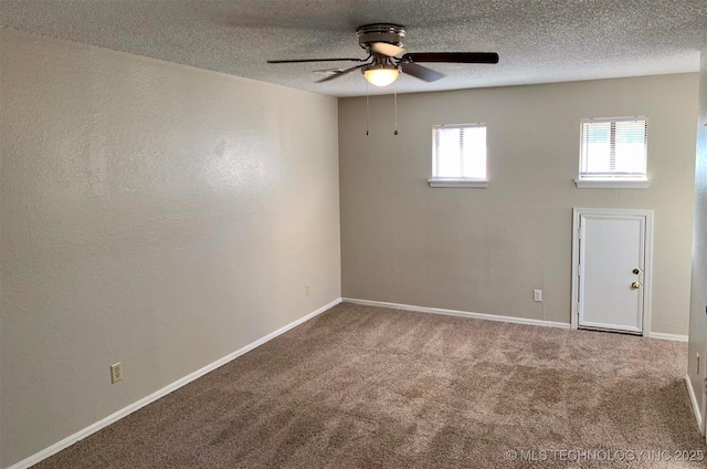 empty room featuring carpet, ceiling fan, and a textured ceiling