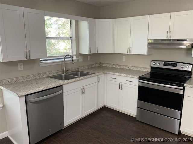 kitchen featuring dark hardwood / wood-style floors, white cabinetry, sink, and appliances with stainless steel finishes