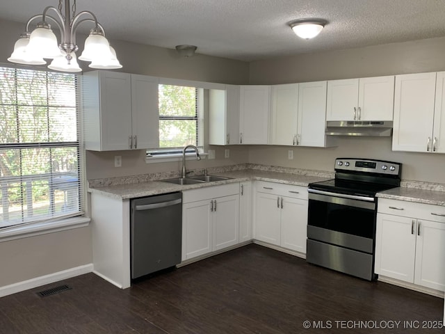 kitchen with pendant lighting, white cabinetry, sink, and stainless steel appliances