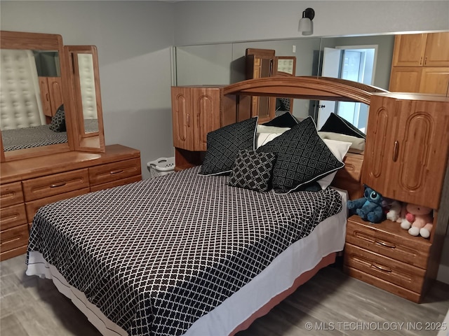 bedroom featuring light wood-style flooring