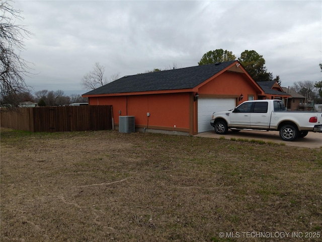 view of property exterior featuring a garage, fence, central AC, and a yard