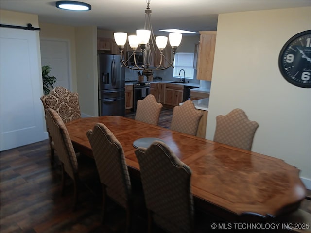 dining area with a barn door, dark wood finished floors, and a notable chandelier