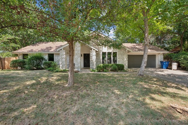 ranch-style house with a garage and a front lawn