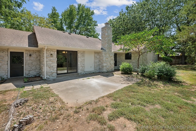 view of front facade with a front lawn and a patio