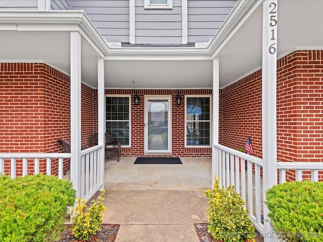 view of exterior entry featuring a porch