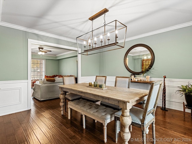 dining space featuring crown molding, ceiling fan with notable chandelier, and dark hardwood / wood-style floors