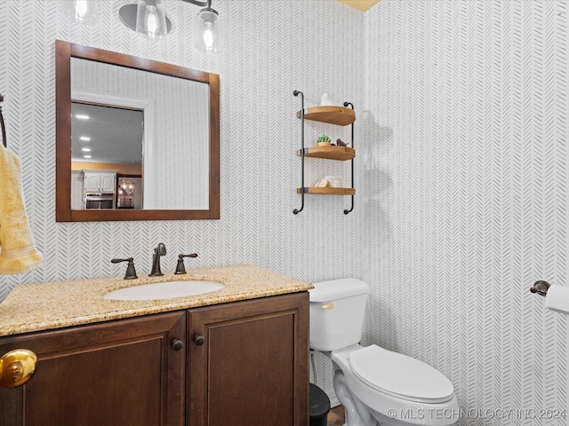 bathroom featuring vanity and toilet