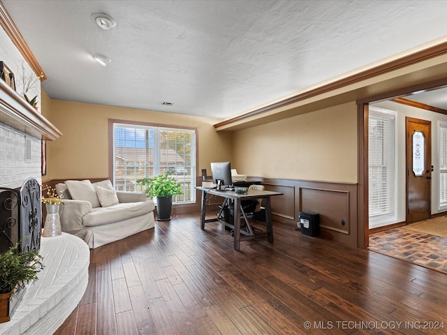 office space featuring a fireplace, dark hardwood / wood-style flooring, and ornamental molding