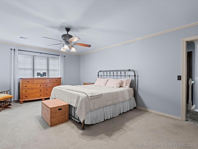 bedroom with ceiling fan, crown molding, and light colored carpet