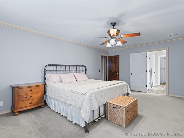 carpeted bedroom featuring ceiling fan and ornamental molding