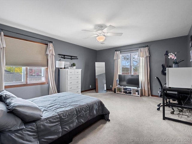 bedroom featuring ceiling fan and light carpet