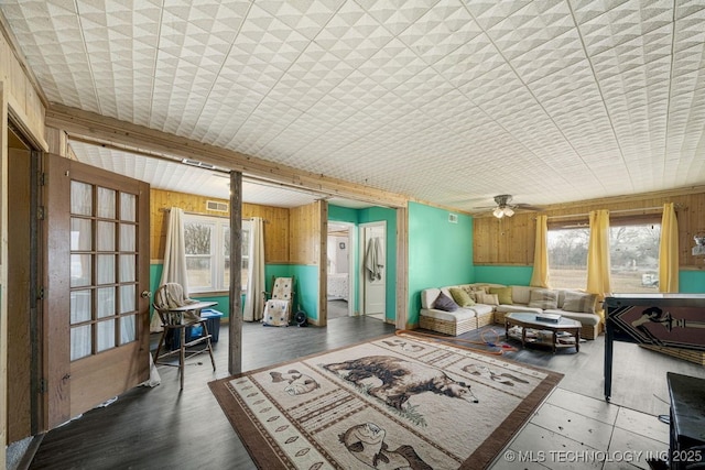 sunroom featuring ceiling fan