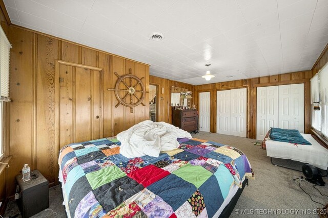 carpeted bedroom with wooden walls