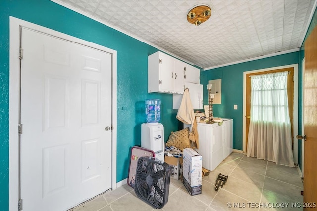 washroom with cabinets, electric panel, light tile patterned floors, washer and dryer, and ornamental molding