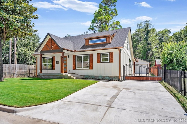 view of front of property with a garage, an outbuilding, and a front lawn