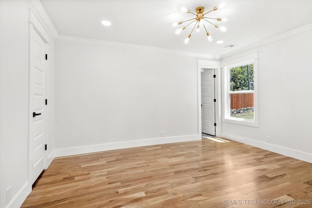 unfurnished room with light hardwood / wood-style flooring, ornamental molding, and a notable chandelier