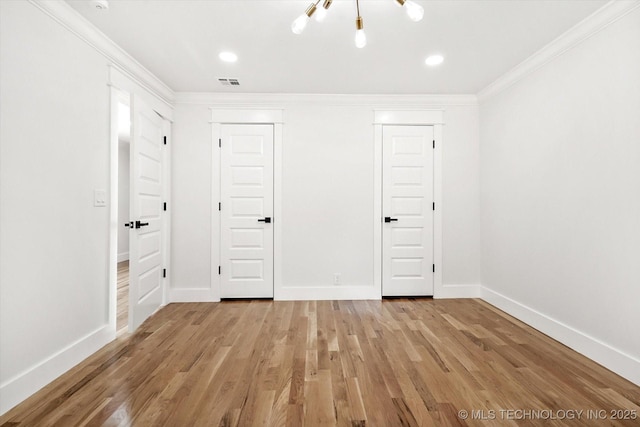 unfurnished bedroom with a chandelier, light hardwood / wood-style floors, crown molding, and a closet