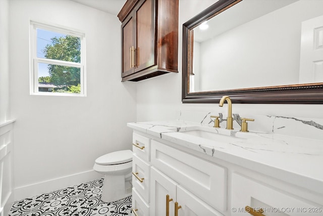 bathroom featuring tile patterned flooring, vanity, and toilet