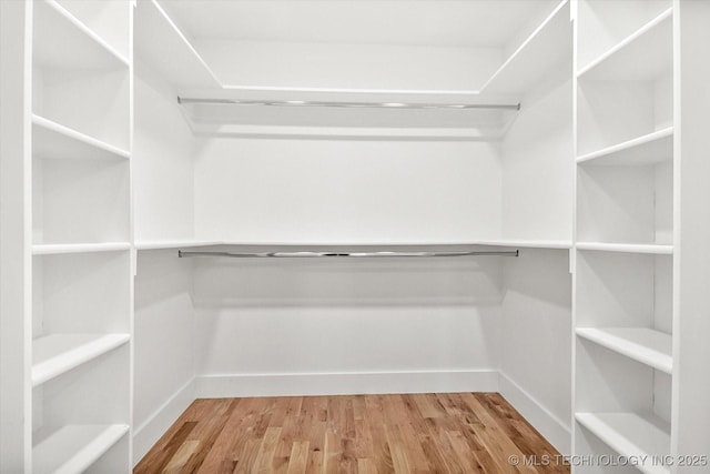 spacious closet featuring hardwood / wood-style floors