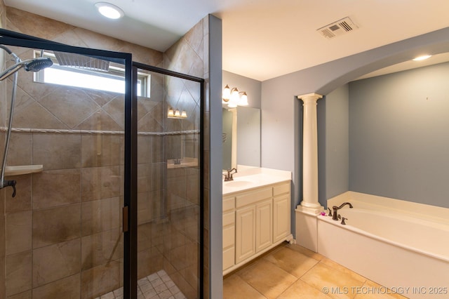 bathroom featuring ornate columns, vanity, tile patterned floors, and plus walk in shower