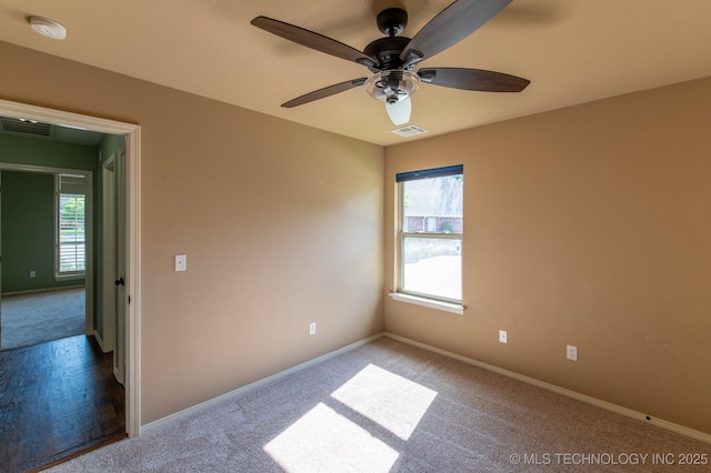 carpeted empty room featuring ceiling fan