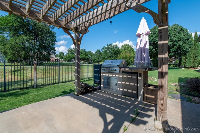 view of patio featuring area for grilling, a pergola, and an outdoor kitchen