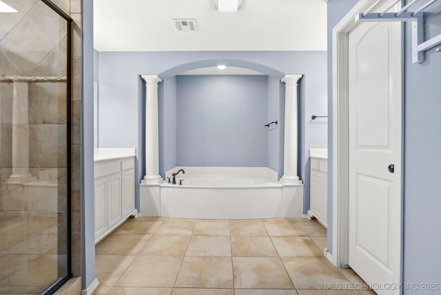bathroom with ornate columns, a garden tub, vanity, and a stall shower