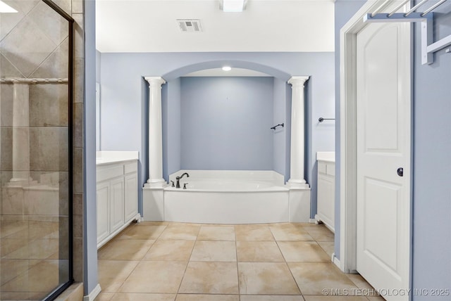 bathroom featuring tile patterned flooring, vanity, and shower with separate bathtub