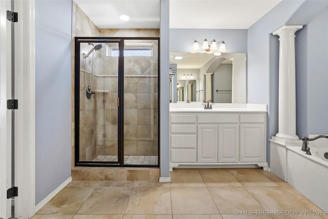 bathroom featuring tile patterned flooring, vanity, ornate columns, and independent shower and bath