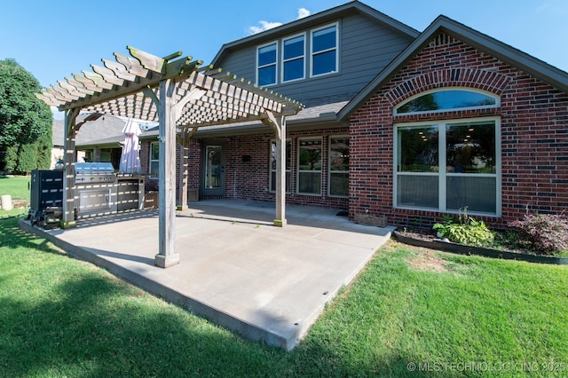 back of house with a pergola, a yard, a patio area, and brick siding