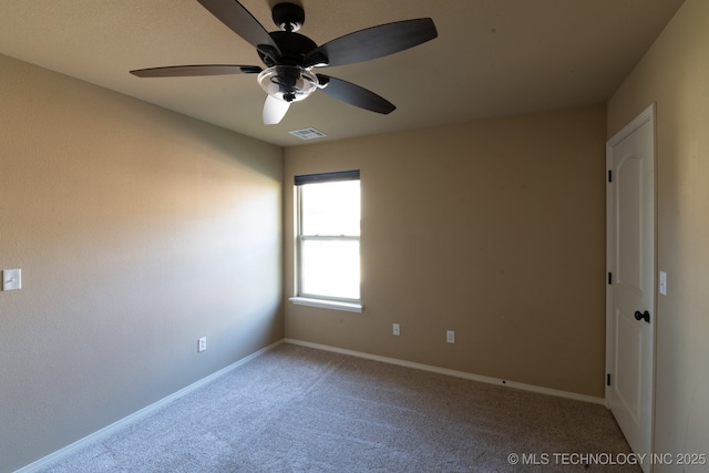 carpeted spare room with ceiling fan