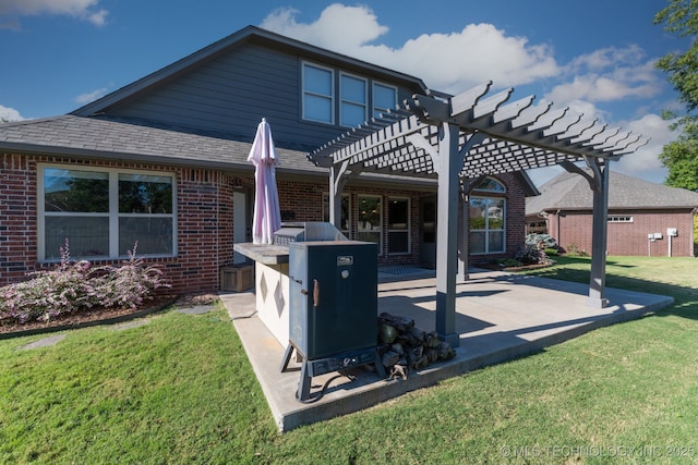 rear view of property featuring a lawn, brick siding, a patio, and a pergola