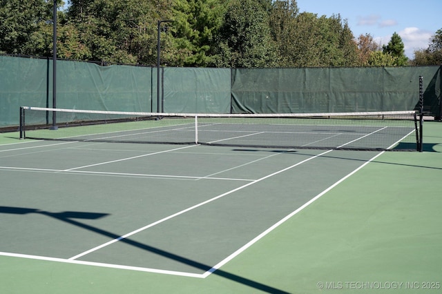 view of tennis court with fence