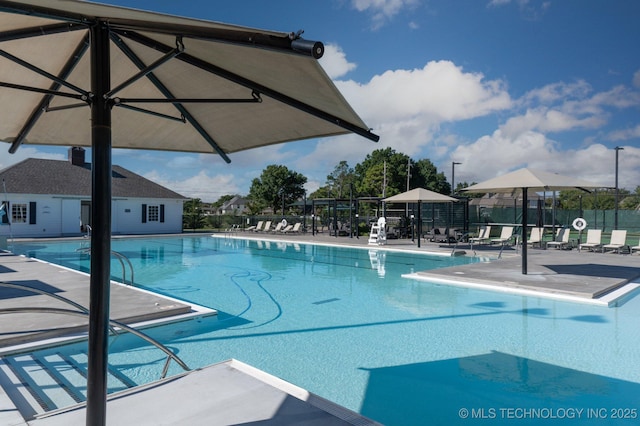 pool featuring a patio and fence