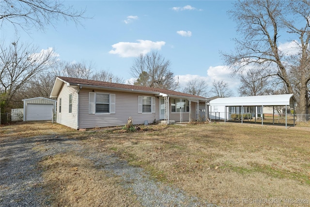 single story home with a front yard, a garage, a carport, and an outdoor structure