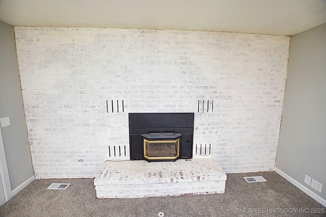 interior details featuring carpet floors and a wood stove