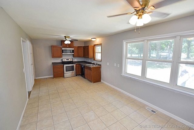 kitchen with ceiling fan, sink, light tile patterned flooring, and appliances with stainless steel finishes