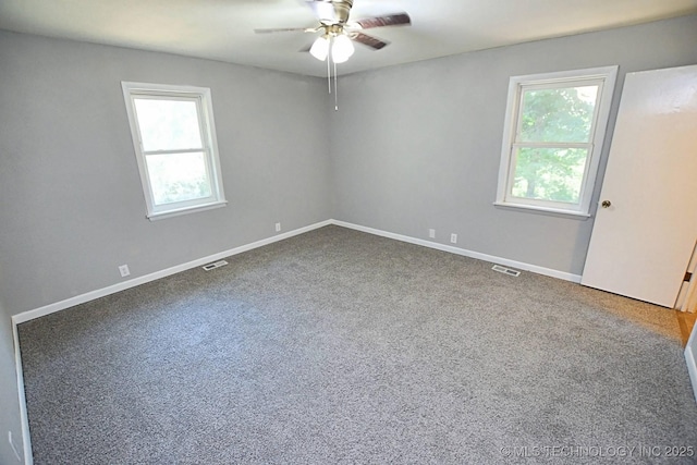 carpeted empty room featuring plenty of natural light and ceiling fan