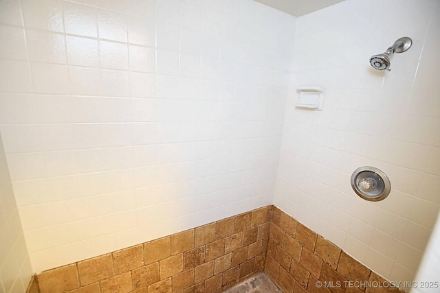 bathroom with tiled shower